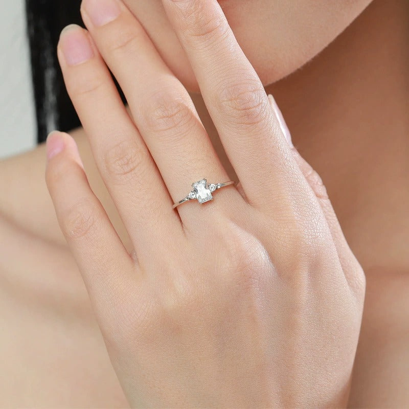 Woman wearing the Sophie radiant silver ring, a rectangular crystal between two small side stones