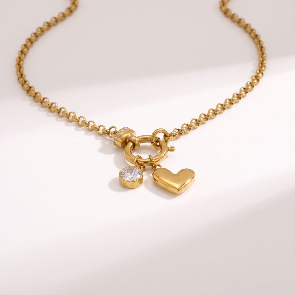 Daphné heart charm gold necklace on a white background showing the charms and clasp