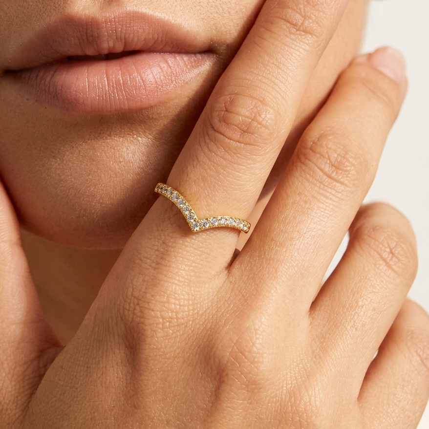 Woman wearing the Zara V-shaped gold ring lined with small clear crystals