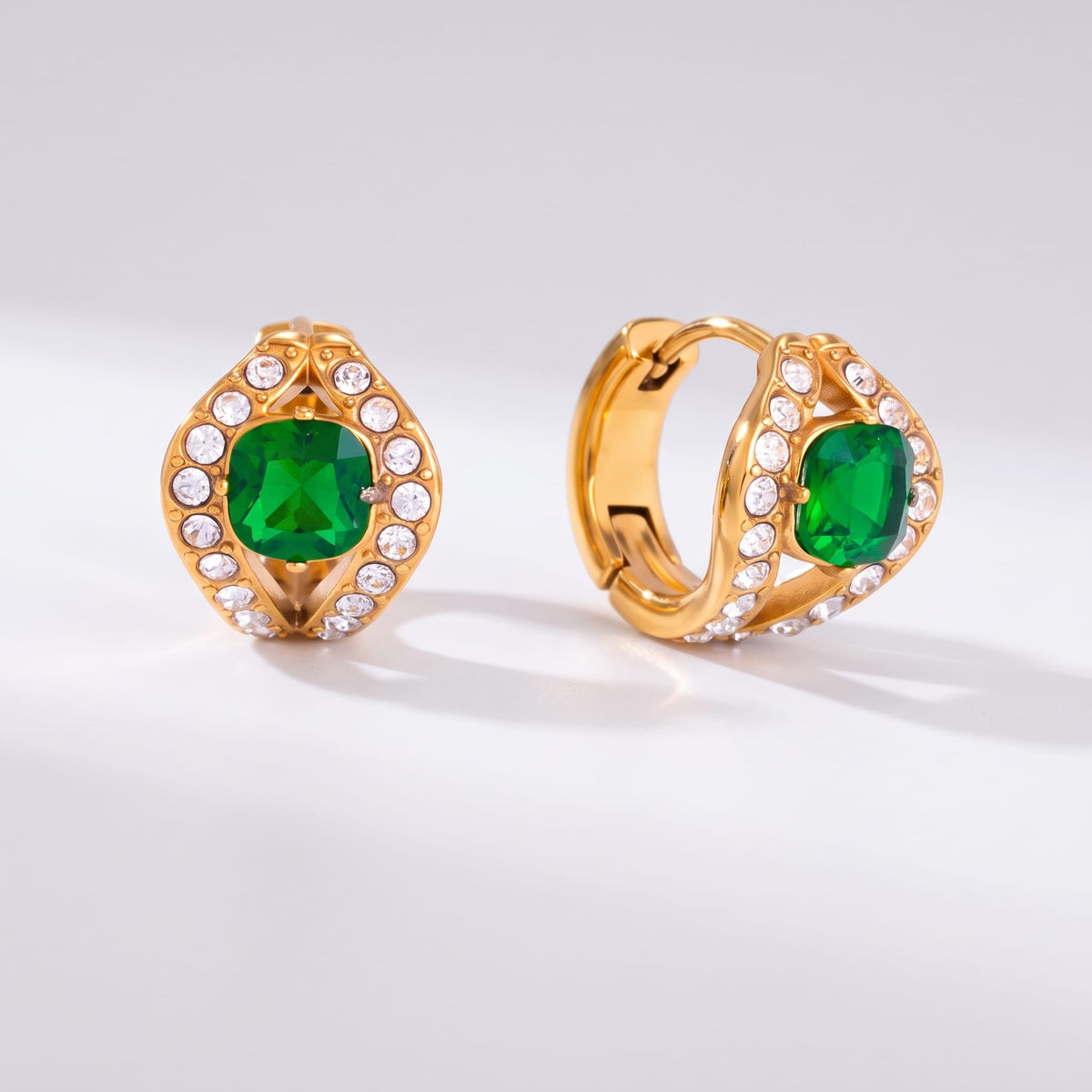 Ilaria green halo gold earrings on a plain white surface showing front and side views