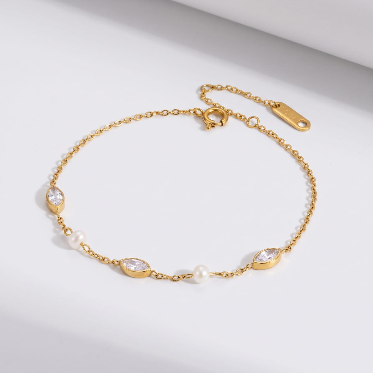 Liana marquise pearl gold bracelet on a white surface with a fine chain design