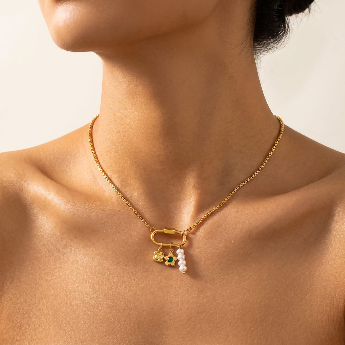 Close-up of a woman wearing the Lilou daisy charm gold necklace at the base of her neck