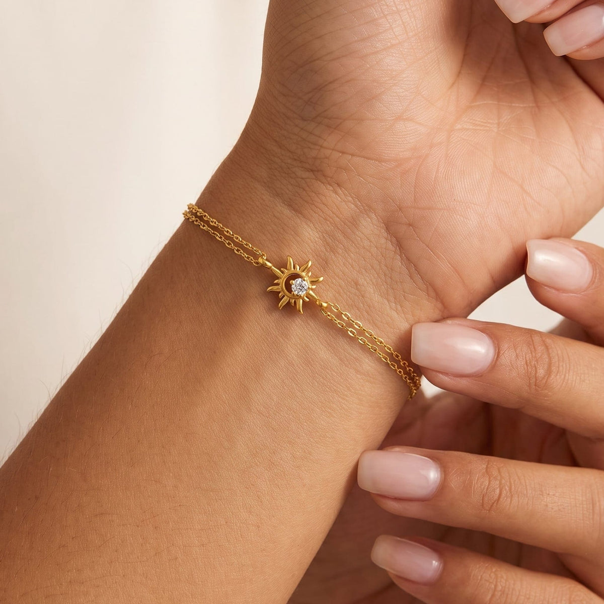 Woman wearing the Olivia crystal sun gold bracelet on the wrist
