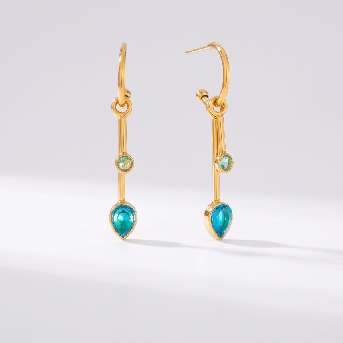 Sixtine blue bar gold earrings on a clean white surface with subtle shadow