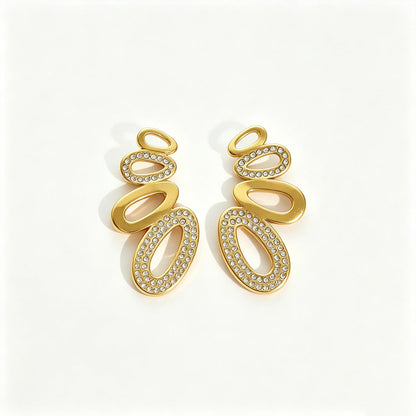 Agathe pavé oval gold earrings, stacked polished and crystal-set ovals, on a white background