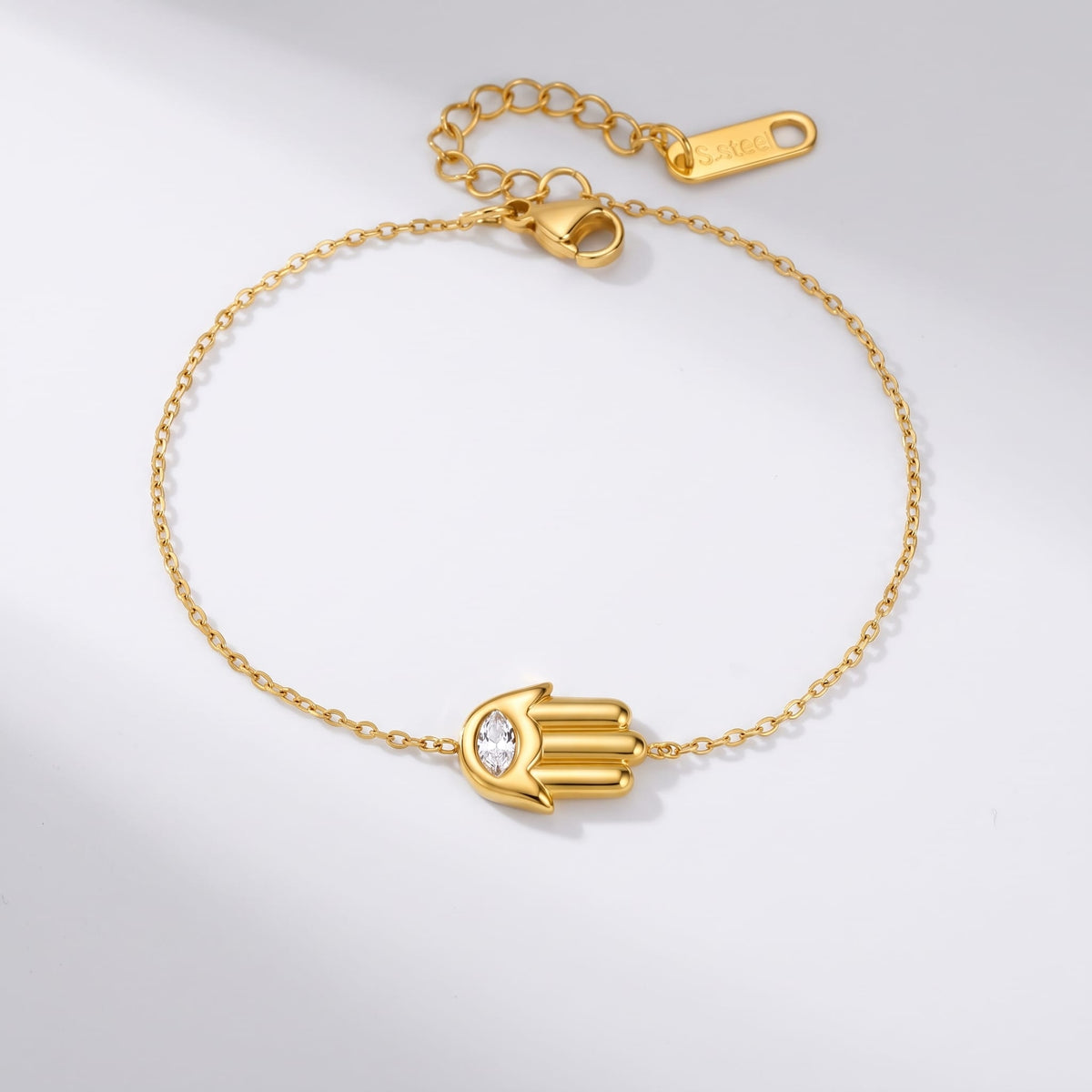 Amelia crystal hamsa gold bracelet on a white background lying flat with clasp open