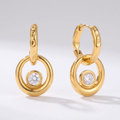Amélie circle drop gold earrings on a plain white background