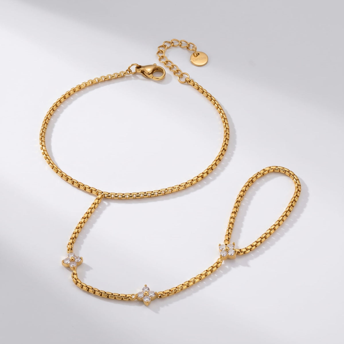 Apolline hand chain gold bracelet on a plain white surface
