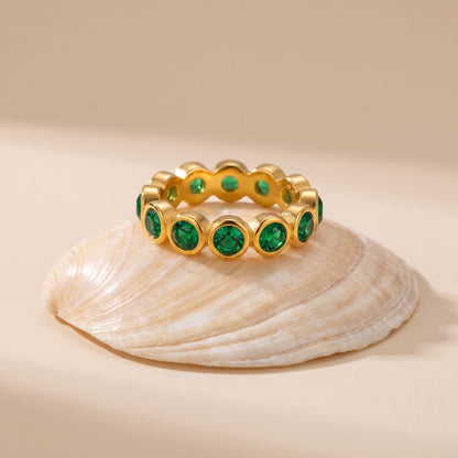 Ariana green round gold ring on a seashells top