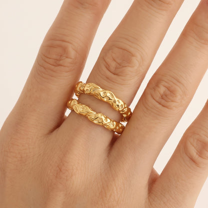 Close-up of the Aurélie hammered double gold ring worn on a ring finger