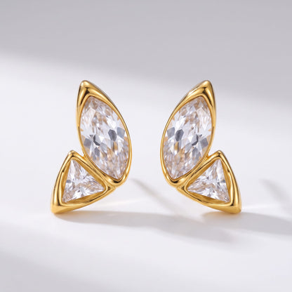 Aurore crystal wing gold earrings on a plain white studio surface