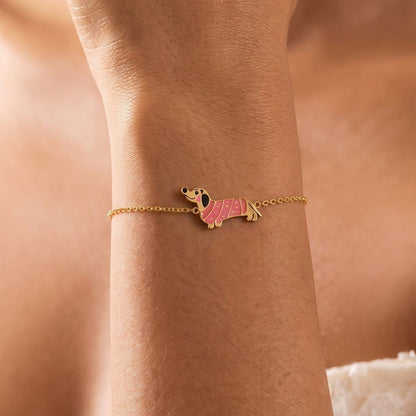 Woman wearing the Bianca pink dachshund gold bracelet on the wrist