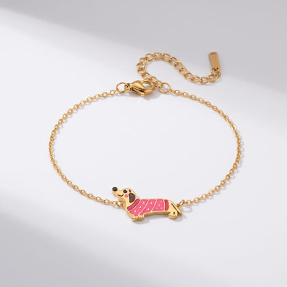 Bianca pink dachshund gold bracelet on a plain white surface with soft light