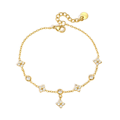 Capucine clover drop gold bracelet with crystal clovers, bezel crystals and a hanging clover on white