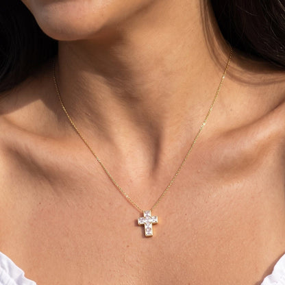 Woman wearing the Chiara crystal cross gold necklace at the collarbone
