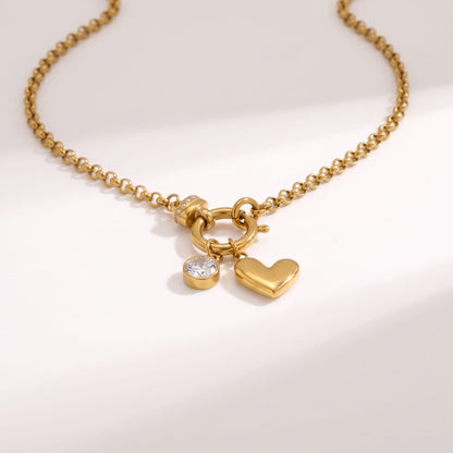 Daphné heart charm gold necklace on a white background showing the charms and clasp