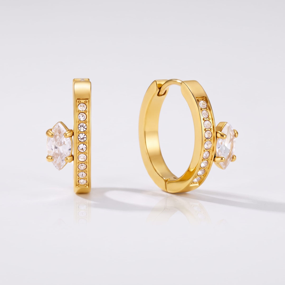Diletta marquise huggie gold earrings on a plain white background