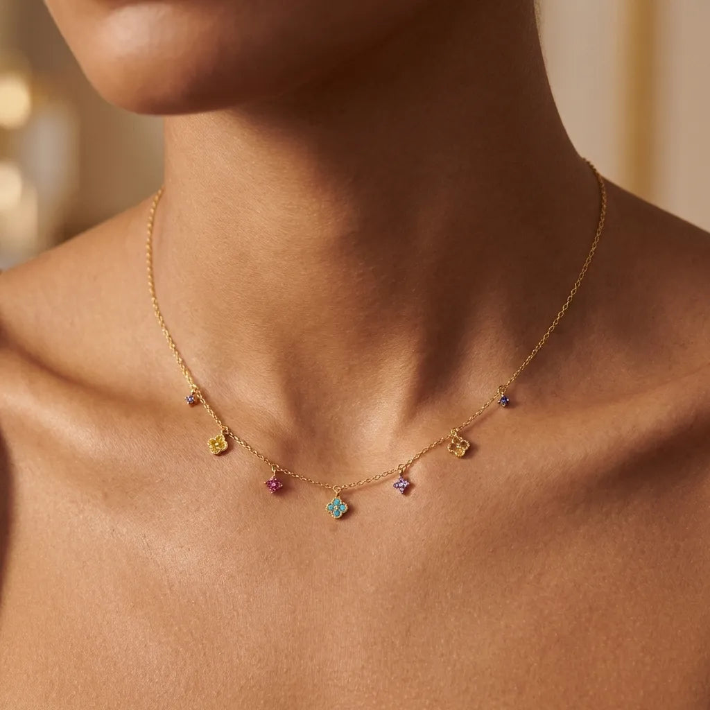 Woman wearing the Aurélie prism charm necklace in gold with multicolored crystal clover charms