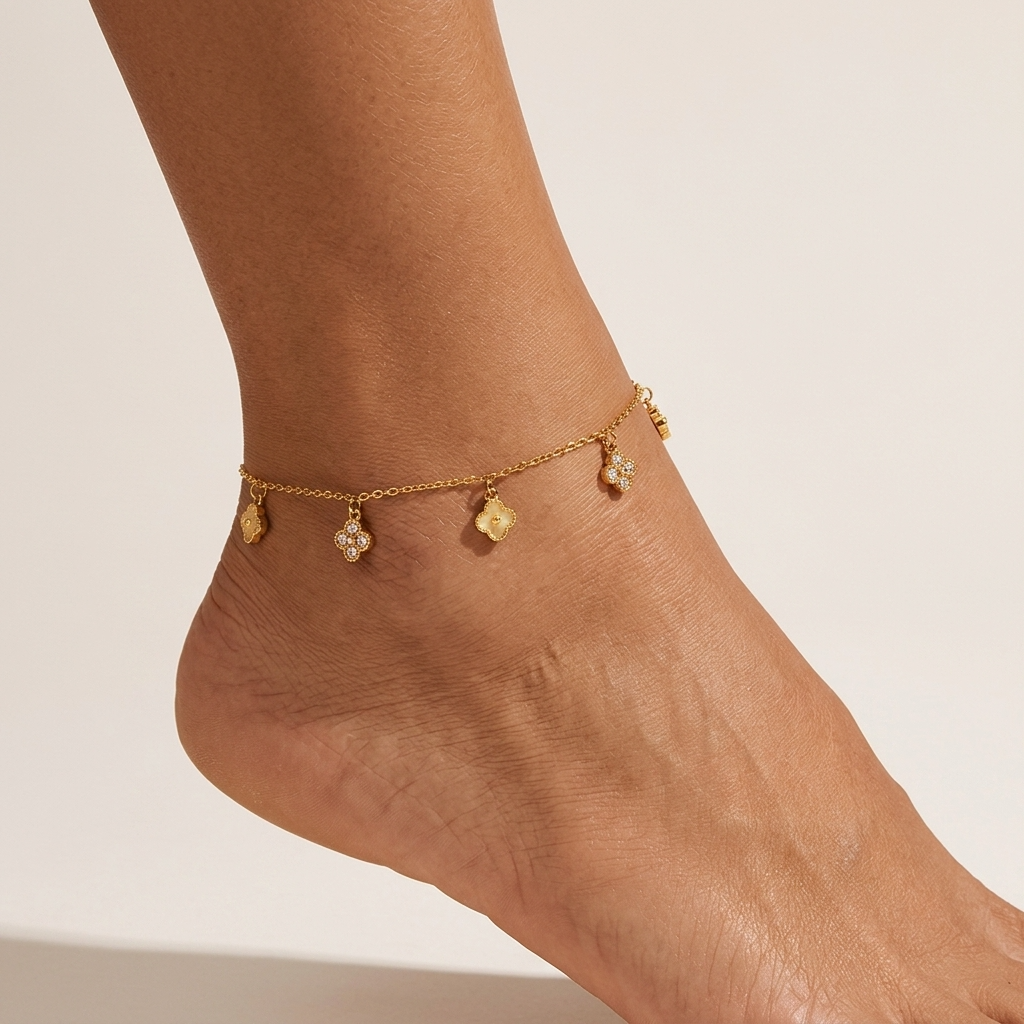 Mia crystal clover anklet on the ankle, plain gold and crystal-set clover charms on a fine chain