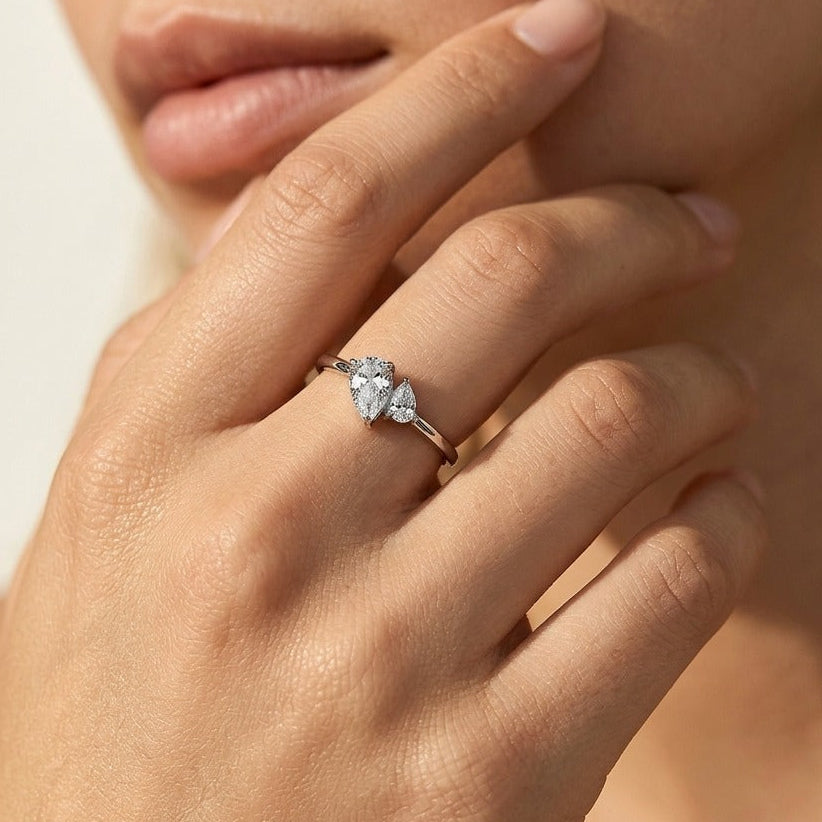 Woman wearing the Luna dual pear silver ring with two pear-shaped crystals set side by side