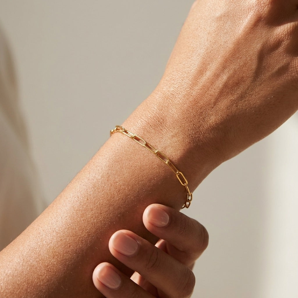 Amelia gold paperclip chain bracelet with long open links worn on the wrist