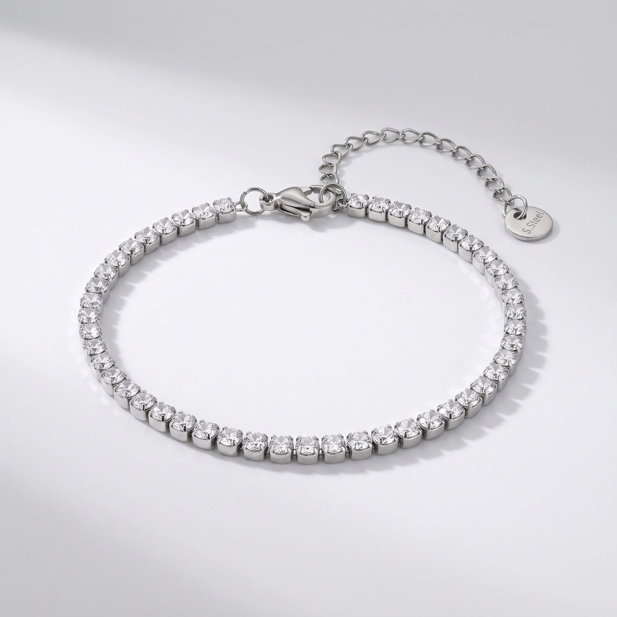 The Emma tennis chain silver bracelet on a light gray background