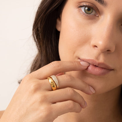 Woman wearing the Evelyne pavé wrap gold ring on the hand touching her lower lip