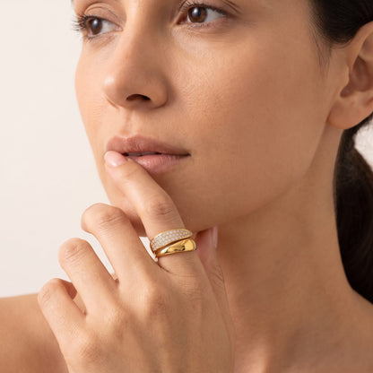 Woman wearing the Evelyne pavé wrap gold ring on the hand resting near her chin