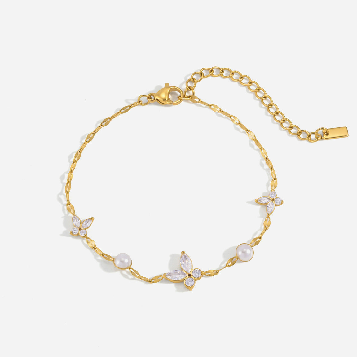 Fabiola crystal butterfly gold bracelet with three butterflies and two faux pearls on white