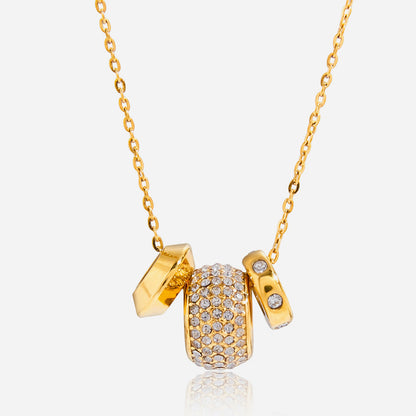 Fiona pavé rondelle gold necklace on white: a crystal barrel bead between two gold rondelle charms
