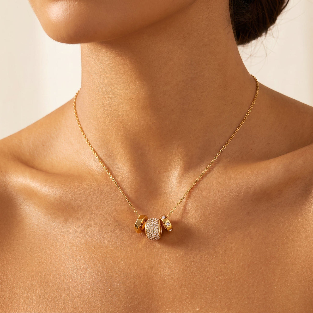 Woman wearing the Fiona pavé rondelle gold necklace at the collarbone
