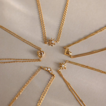 Juliette love knot bracelet in a star-shaped layout of five gold charm bracelets