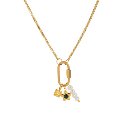 Lilou daisy charm gold necklace: a box chain with a gold carabiner clasp holding a yellow square crystal, a gold daisy with a green centre and a pearl drop