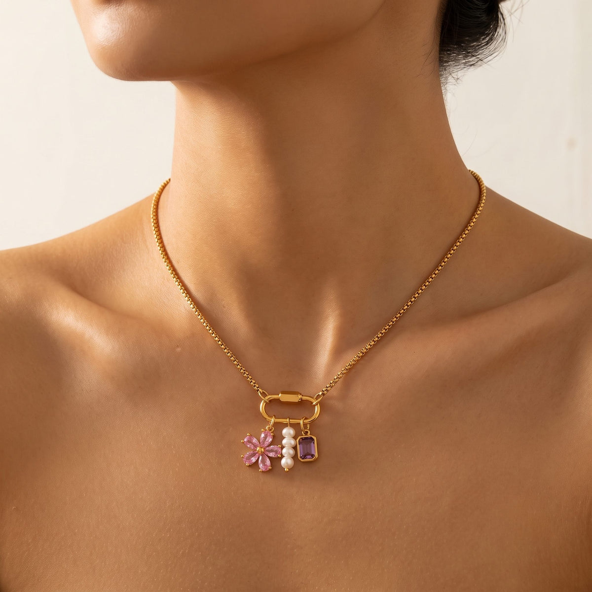 Close-up of a woman wearing the Lilou flower charm gold necklace at the base of her neck