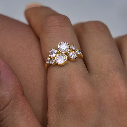 Close-up of a finger wearing the Louise bubble cluster gold ring