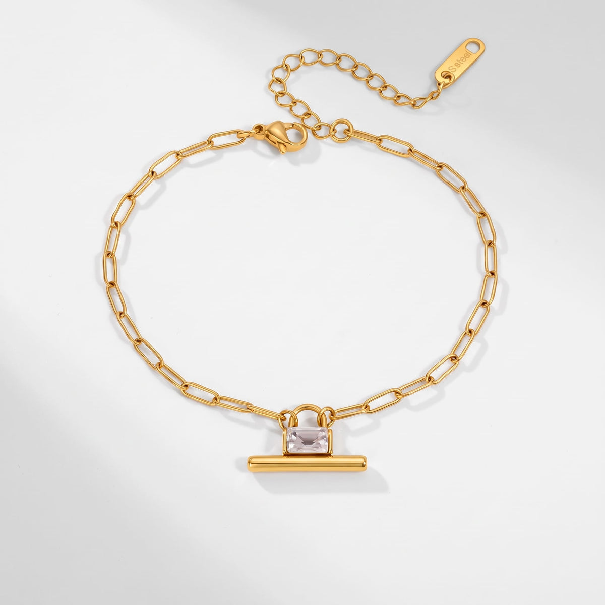 Margaux padlock t-bar gold bracelet on a white surface with an adjustable extender chain