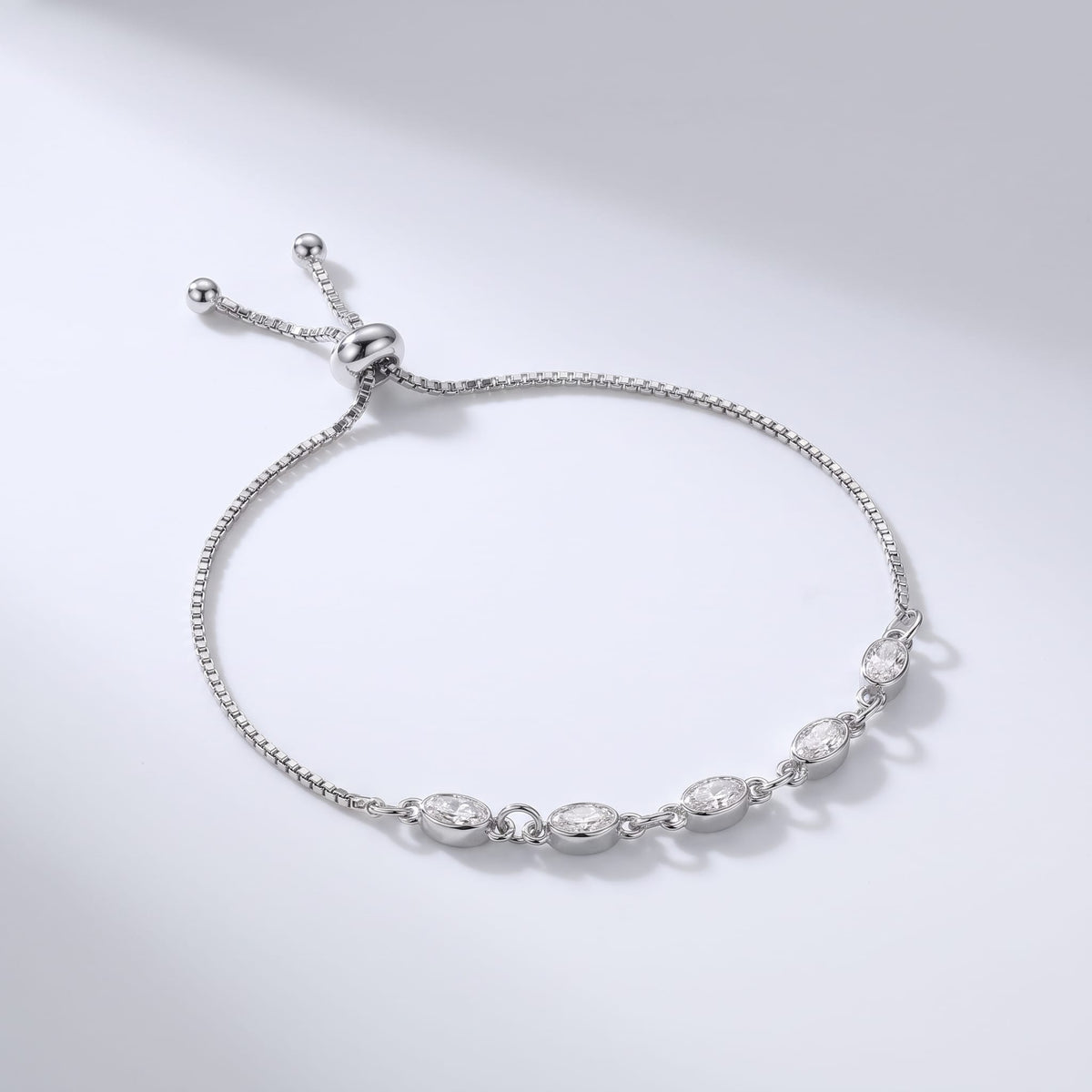 Marisa oval crystal silver bracelet on a light gray surface with slider clasp and box chain
