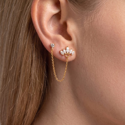 Double-piercing gold earring: crystal stud linked by a fine chain to a marquise crystal crown