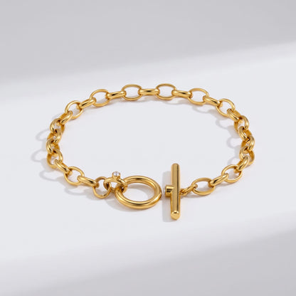 Ornella circle toggle gold bracelet on a plain white surface displaying its clasp design