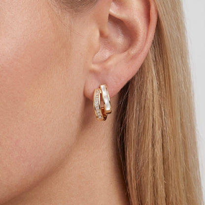 Woman wearing the Pearl & Crystal earring, a baguette crystal row beside a glossy white band