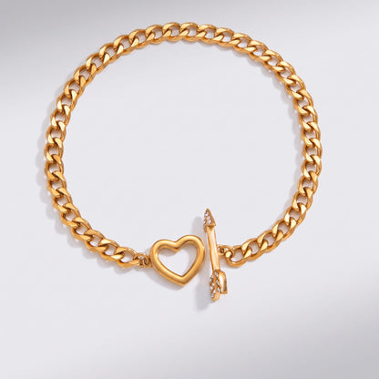 Rafaella heart arrow gold bracelet on a plain white surface showing the open toggle clasp