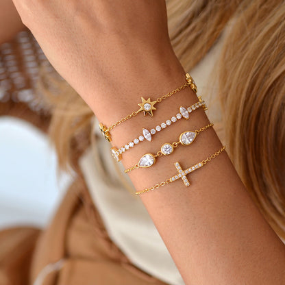 Sienna marquise tennis bracelet worn second in a stack of four crystal gold bracelets