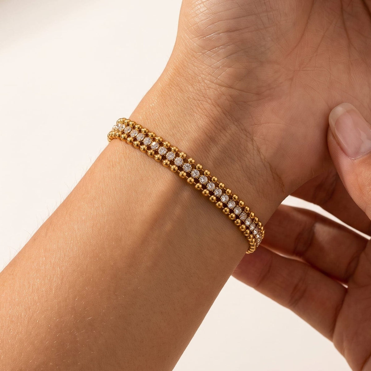 Woman wearing the Sofia bead tennis gold bracelet on the wrist