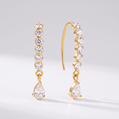 Sol(ne crystal drop gold earrings on a plain white surface displaying hook wire and zircon drops