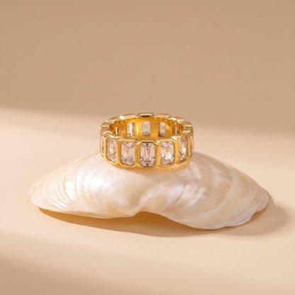 Sophie baguette eternity gold ring on a white seashell