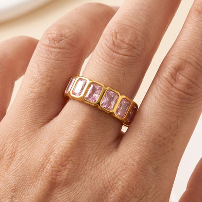 Woman wearing the Sophie pink baguette gold ring on the hand, featuring pink crystals