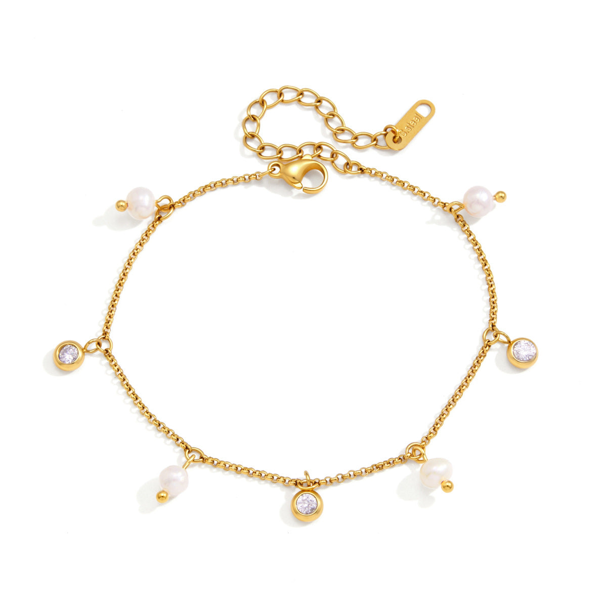 Teresa pearl charm gold bracelet laid open on white, pearls and crystal charms spaced around the chain