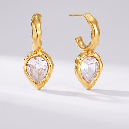 Victoire hammered teardrop gold earrings on a white plain background