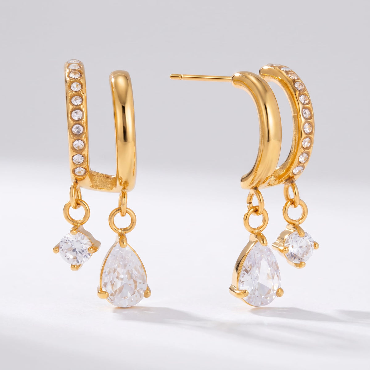 Ysaline double hoop gold earrings on a plain light grey background