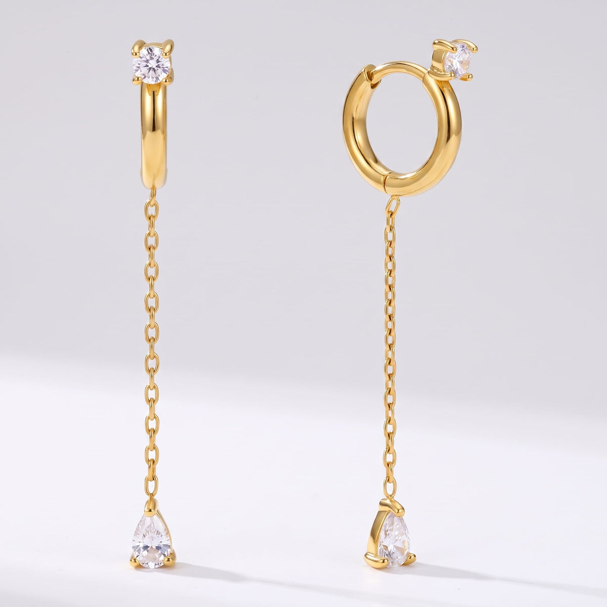 Yvette chain drop gold earrings on a plain white background